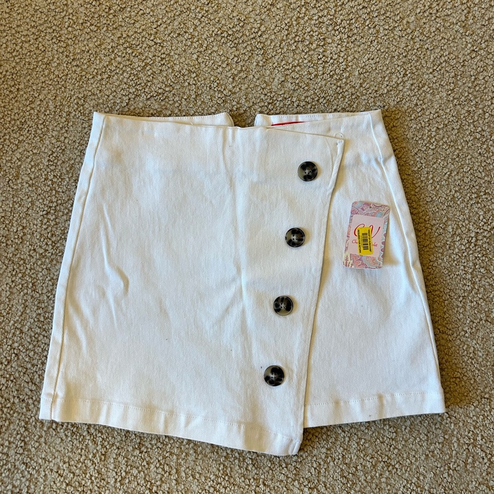 white denim skirt, asymmetrical front with buttons